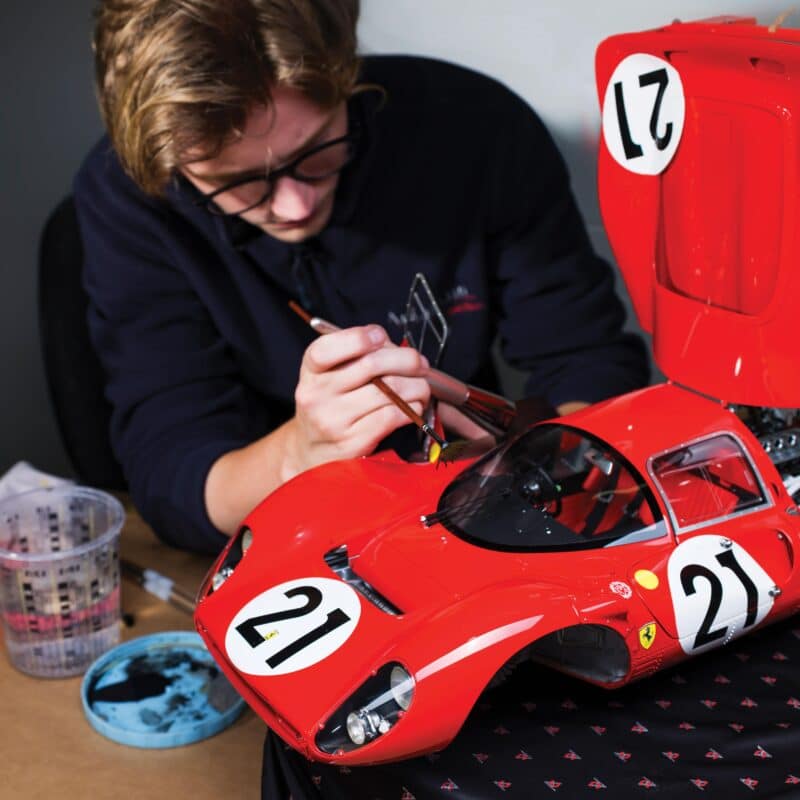 Man paints model car amalgam factory