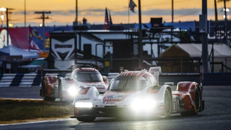 Sister Penske Porsches at night